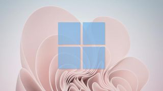 青い Windows 11 ロゴが重ねられた Windows 11 の壁紙。Windows でクリップボード履歴を有効にする方法に関する記事を表しています。