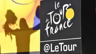 Tour de France logo with silhouette of yellow jersey leader on the podium