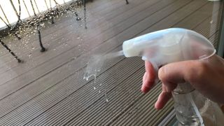 窓ガラスにスプレーされる白い蒸留酢