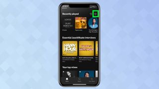 設定の歯車が強調表示された Spotify アプリを示す iPhone のスクリーンショット